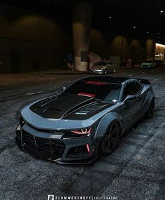 the chevrolet camaro zr1 is parked in an empty parking lot at night