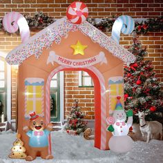 an inflatable christmas house is decorated with candy canes, snowmen and decorations