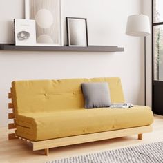 a living room with a yellow futon couch