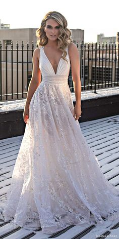 a beautiful woman in a white dress standing on a wooden floor with her hands behind her back