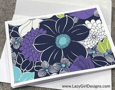 two cards with blue and purple flowers on them, one is folded in white paper