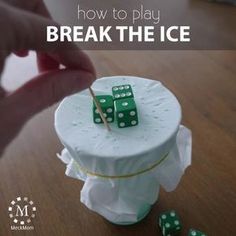 a cake with dices on it and the words how to play break the ice