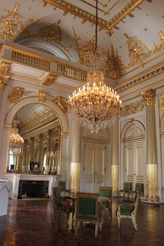 a fancy dining room with chandelier and chairs in it's center hall