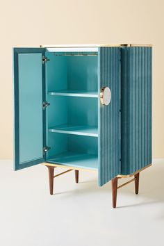 a blue cabinet sitting on top of a white floor