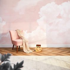 a pink chair sitting in front of a wall with clouds painted on it and a blanket draped over it