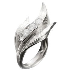 This contemporary Lily of The Valley Engagement Ring is made of 18 karat white gold and 4 round diamonds (0,65 carats). It has a sculptural shape. We use the best natural diamonds VS, F-G, we work with German gemstone companies that have been in business since the 19th century. The ring can be personalised with a name or a saying. Please allow us time to customize the ring. The ring can be ordered as usual fashion ring. The size and the colour of the gold can be changed. Lily Of The Valley Ring, Cricut Jewelry, Round Sapphire, White Gold Engagement, Fashion Ring, Gold Engagement, Lily Of The Valley, Jewelry Rings Engagement, The Valley