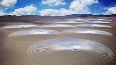 an array of circles in the desert under a blue sky