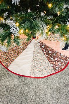 a christmas tree skirt hanging from the top of a pine tree