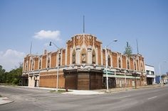 an old brick building sitting on the corner of a street