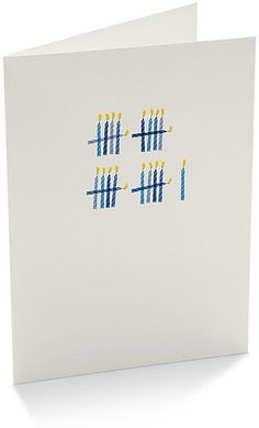 a white card with blue and yellow dots on it, in the shape of numbers