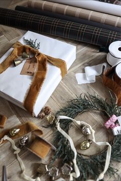 several wrapped presents on the floor with ribbons