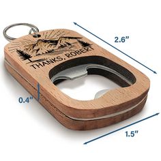 a wooden keychain with a bottle opener attached to it's side and measurements