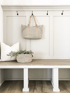 a white bench with a bag hanging on it