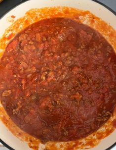 a pan filled with chili sauce on top of a stove