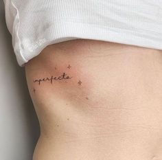 a woman's stomach with the word imperfect written in cursive writing on it