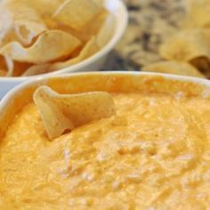 two white bowls filled with dip and chips