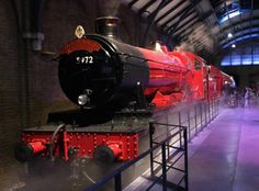 a red and black train on display in a museum