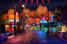 an empty street at night with neon lights