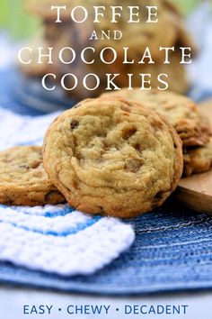 two chocolate chip cookies sitting on top of a blue towel