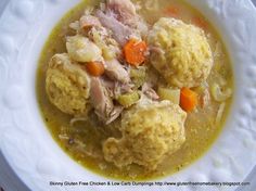 a white plate topped with meat and dumplings covered in gravy