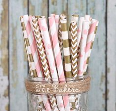 pink and gold striped paper straws in a mason jar