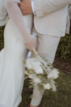 the bride and groom are holding each other close together