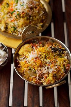 two bowls filled with food sitting on top of a wooden table