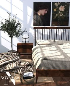 a bed sitting in a bedroom next to a plant and pictures on the wall above it