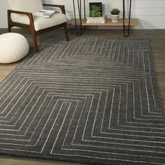 a living room with a chair and rug on the floor