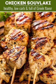 grilled chicken skewers on a bamboo platter with green garnish