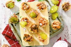 an overhead view of some appetizers on a tray with pickles and celery