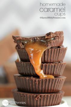 chocolate cups stacked on top of each other with caramel sauce drizzled over them