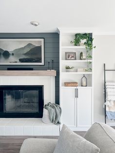 a living room filled with furniture and a fire place in front of a wall mounted tv