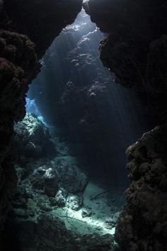 an underwater cave with sunlight coming through the water