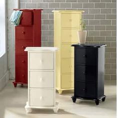 there are four different colored filing cabinets in this room, one is white and the other is black