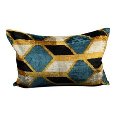 a blue and gold pillow with black, white, and yellow squares on it's sides