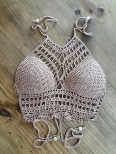 a crocheted bralet on a wooden floor