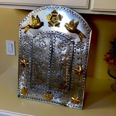 a metal fire place cover sitting on top of a counter