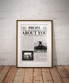 an old newspaper with the words about you on it in front of a wooden floor