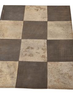 a brown and white rug with squares on the floor in front of a white background