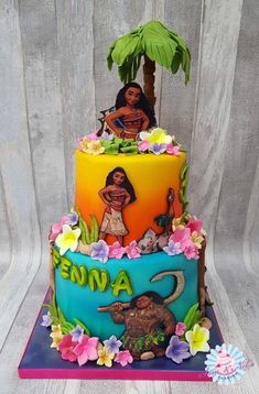 a multi - tiered cake decorated with an image of moan and tiki