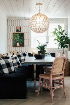 a living room filled with furniture and a large lamp hanging over the top of it