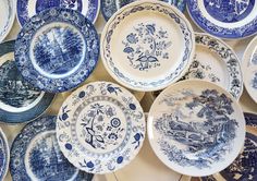 many blue and white plates stacked on top of each other