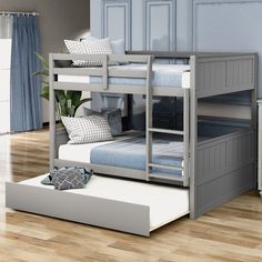 a bunk bed with two sets of mattresses on the bottom and one set below