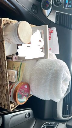 the interior of a car with toiletries and other items in baskets on the dash board