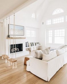 a living room filled with furniture and a fire place in the middle of a room