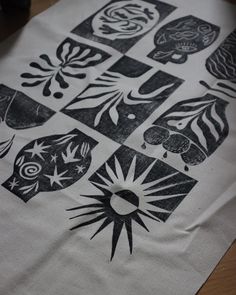 a white table cloth with black and white designs on it