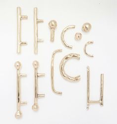 four pairs of gold ear clips on a white background with the letters effc and focci written below them