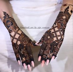 two hands with henna designs on them