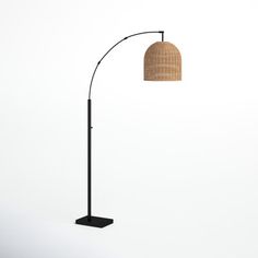 a floor lamp with a brown shade on it's side and a black base